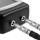 Close-up of a device with audio cables plugged into it on a white background